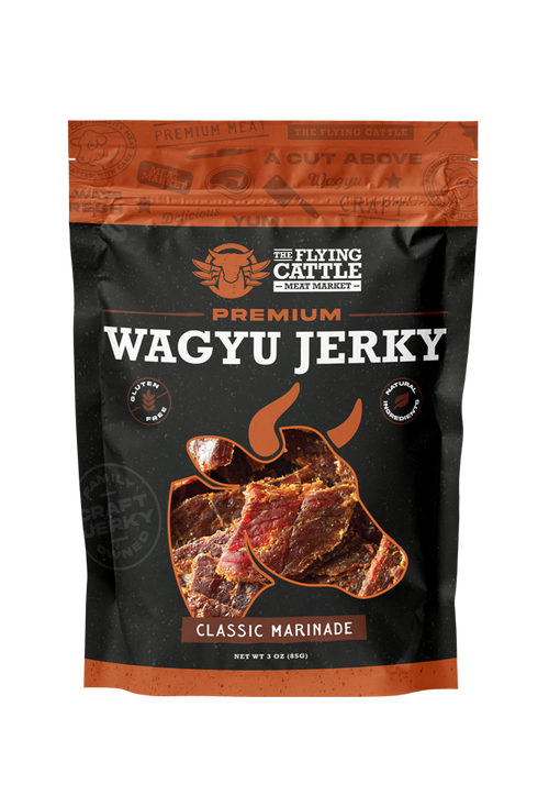 A 3 oz bag of The Flying Cattle Premium Wagyu Jerky in Classic Marinade, featuring a black and orange design with a graphic of marinated beef slices.