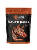 A 3 oz bag of The Flying Cattle Premium Wagyu Jerky, Teriyaki flavor. The packaging is black with orange accents and features a graphic of sliced wagyu jerky.